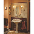 Cream-colored ceramic pedestal sink with ornate gold-toned faucets from cameo carousel 5-tile set on county white