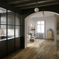Canaiolo Rovere dark wood-effect flooring with a black-framed glass partition