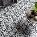 Black and white patterned Carnaby Hexagon black floor tiles with a repeating floral design for stylish flooring