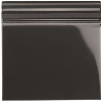 A glossy black ceramic charcoal grey skirting tile with a smooth reflective surface and subtle horizontal ridges