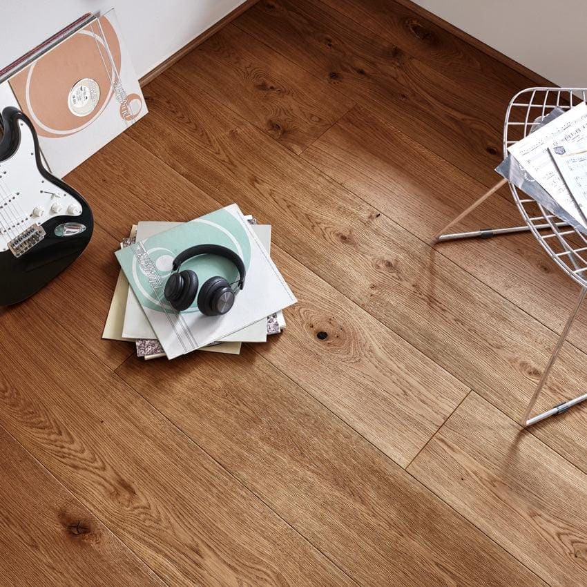 Black over-ear headphones resting on a stack of light-colored magazines with chepstow distressed charcoal oak finish