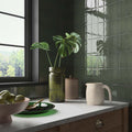 Clay Olive Ceramic Glazed Wall Tile 65x130mm olive green glazed wall tiles with a green ceramic vase and monstera plant