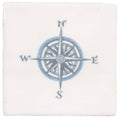 White ceramic coaster with detailed blue compass rose design and cardinal directions in compass blue on cotton style