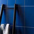 Danube Clear Glass 398 x 198mm deep blue glass tiles with a black towel ladder