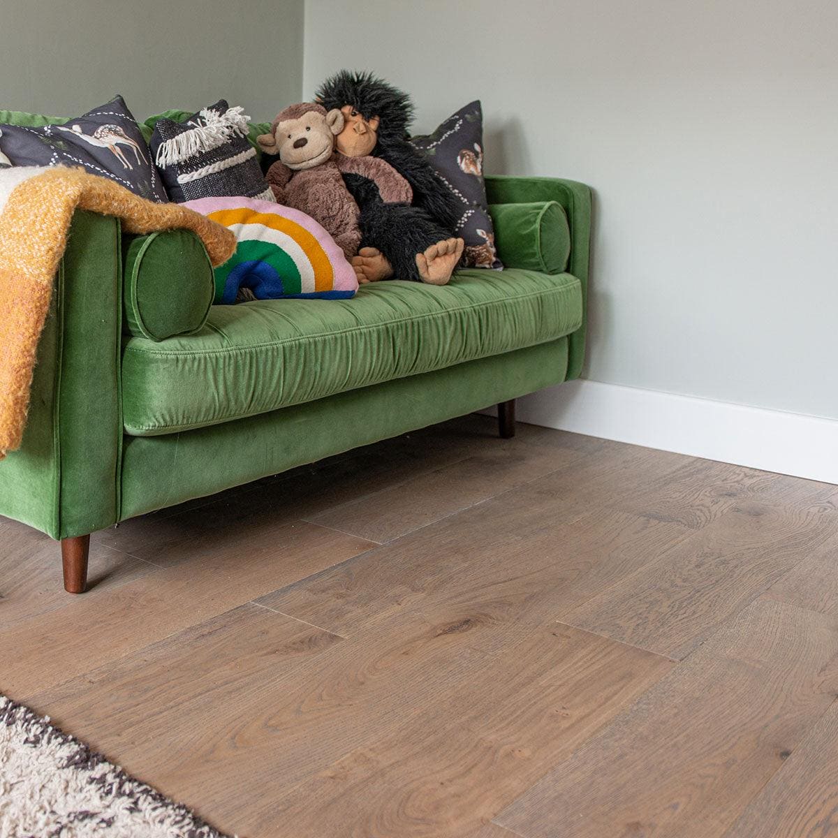 DC101 Deco Frozen Umber engineered wood flooring with a green velvet sofa