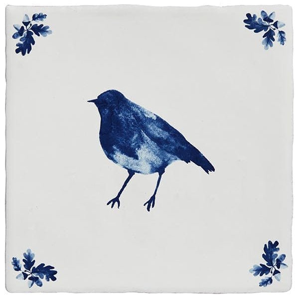 A square ceramic tile from dyrham dairy ceramic decors with a blue bird illustration and decorative leaf motifs