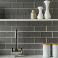 Erebos Metallica Brick grey metallic glass tiles with a chrome tap