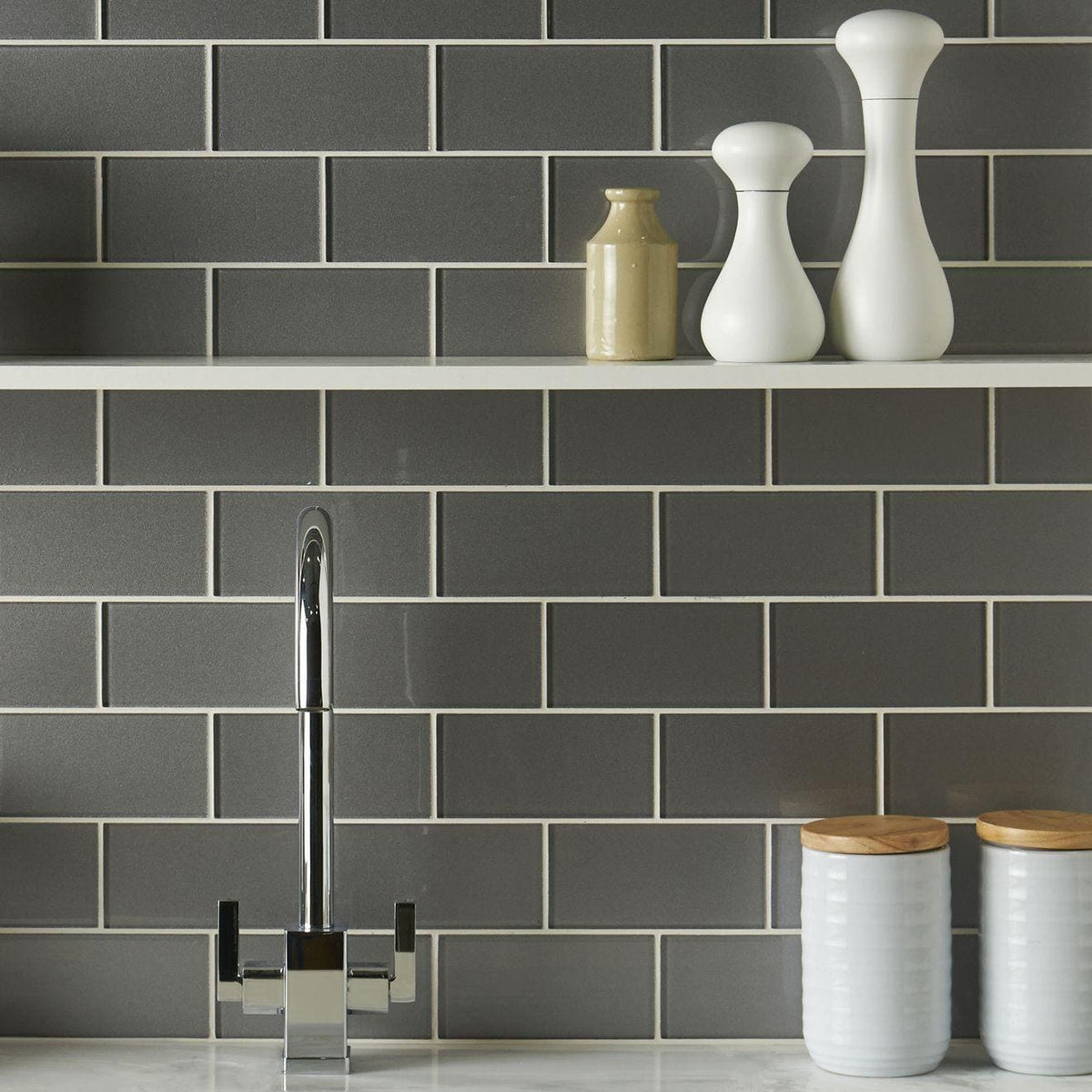 Erebos Metallica Brick grey metallic glass tiles with a chrome tap