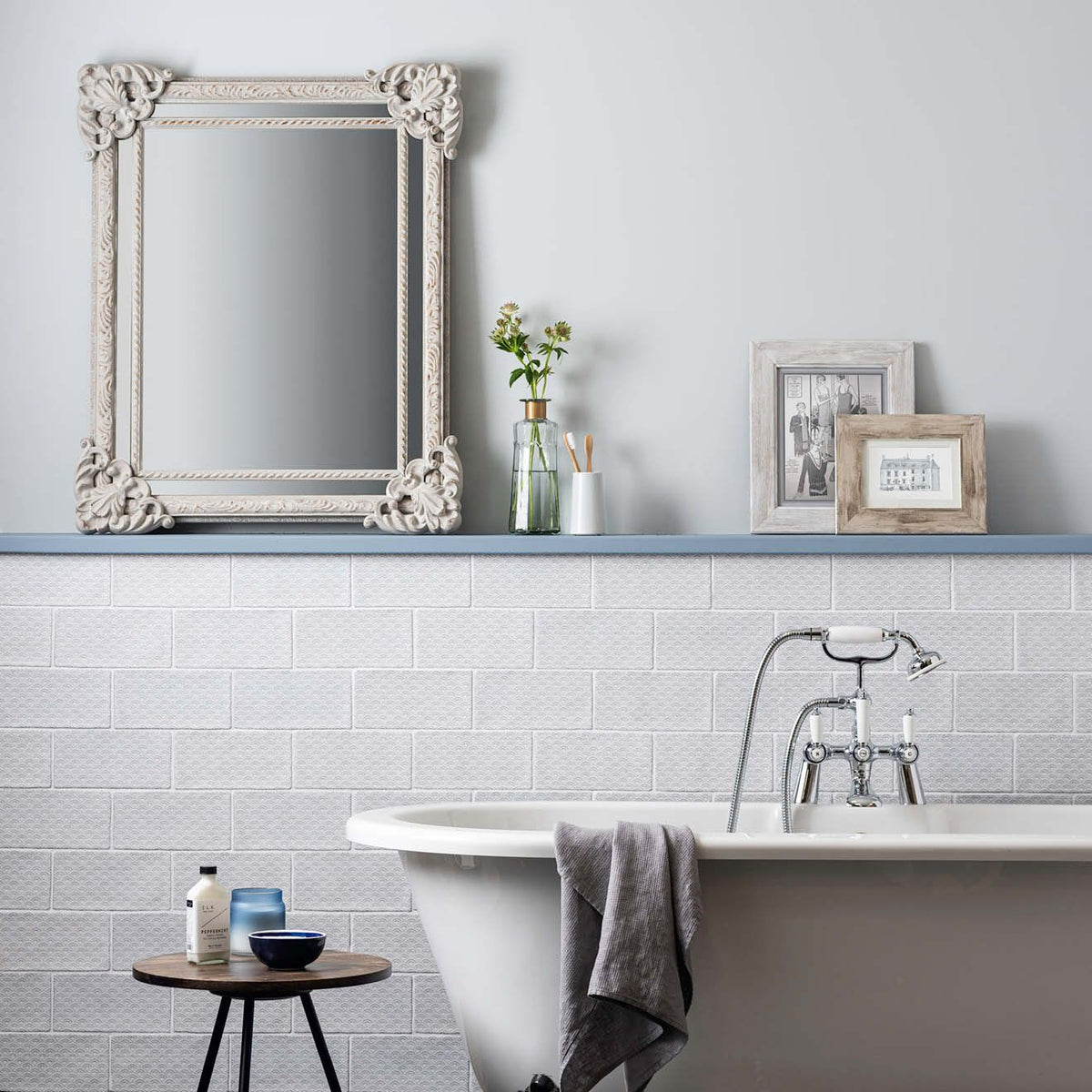 White ornate mirror with intricate floral detailing on fabrique rosaline french blue frame