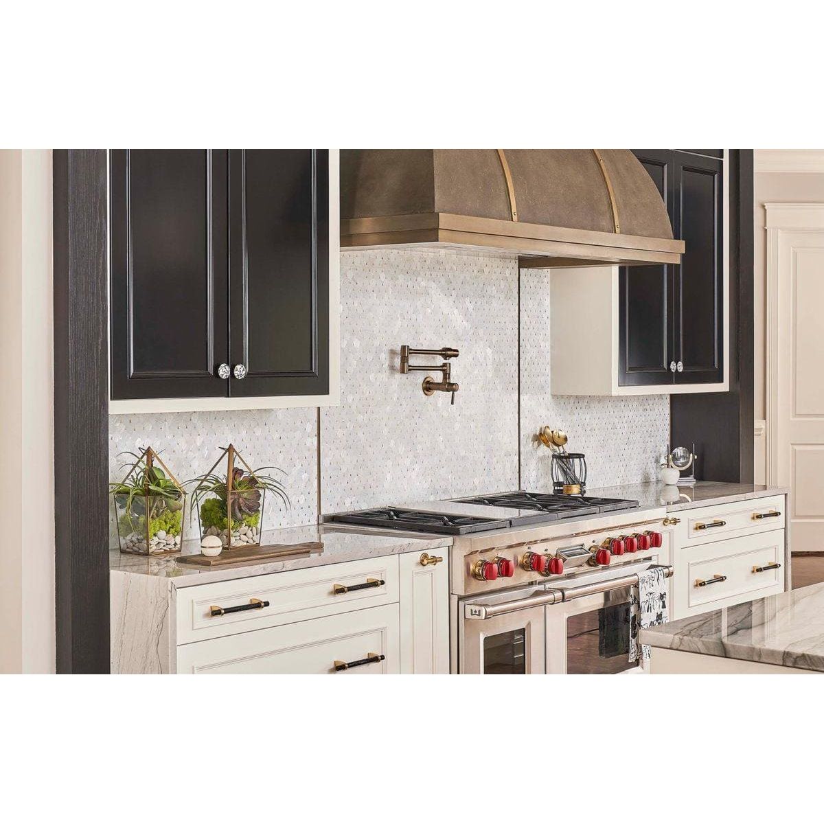 Feature Panel Pearl Drop pearlescent shell mosaic panel with a stainless steel range and bronze hood
