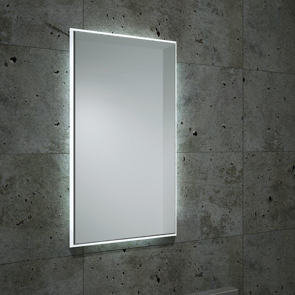 Rectangular frameless fractal mirror 120 with integrated led lighting mounted on a textured concrete wall