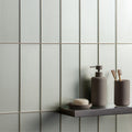 Galatea Metallica grey metallic glass tiles with a soap dispenser
