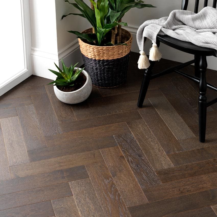 Dark brown herringbone patterned hardwood floor planks made of goodrich espresso oak for stylish interior flooring
