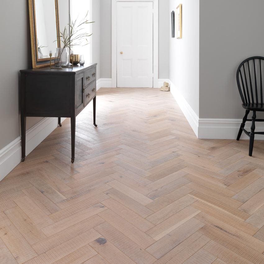 Light-colored Goodrich salted oak hardwood floor with a herringbone pattern showcasing natural wood grain