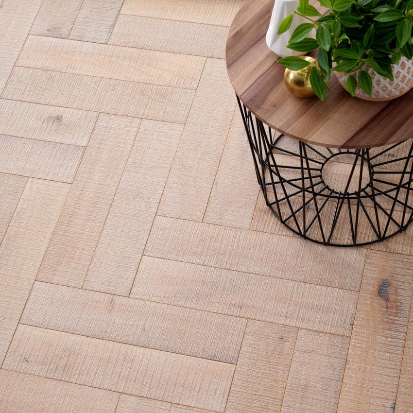 Goodrich salted oak light beige wood-effect floor tiles arranged in a herringbone pattern for stylish flooring