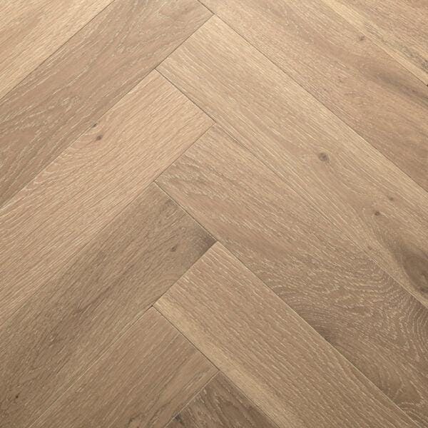 Light brown Goodrich white smoked oak hardwood flooring with a herringbone pattern for elegant interiors