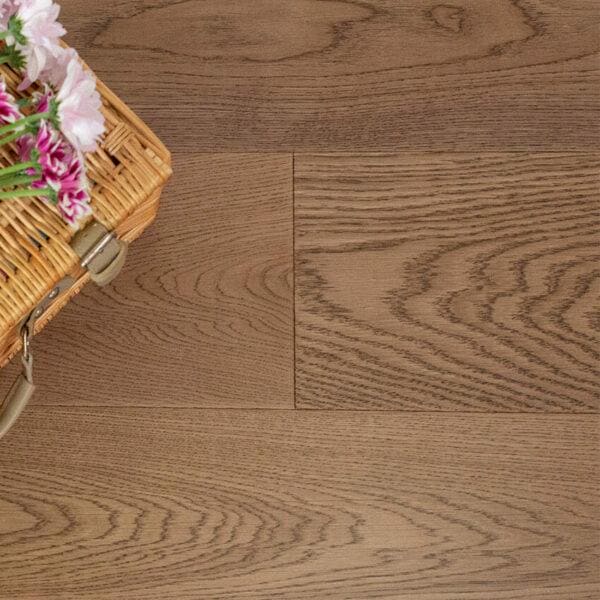 Light brown Harlech Biscotti oak hardwood flooring with a natural wood grain pattern in oak material