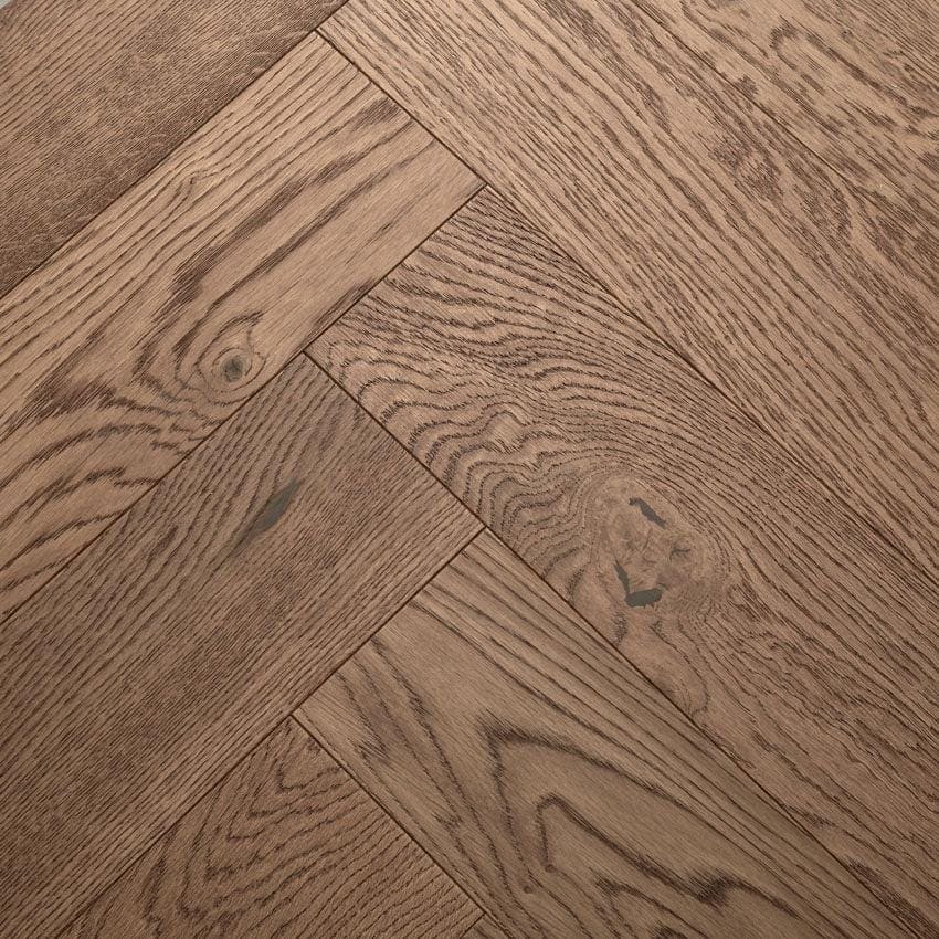 Highclere coffee oak brown oak hardwood floor planks arranged in a herringbone pattern