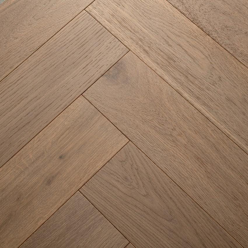 Warm-toned highclere feather oak hardwood flooring in a classic herringbone pattern with natural oak finish