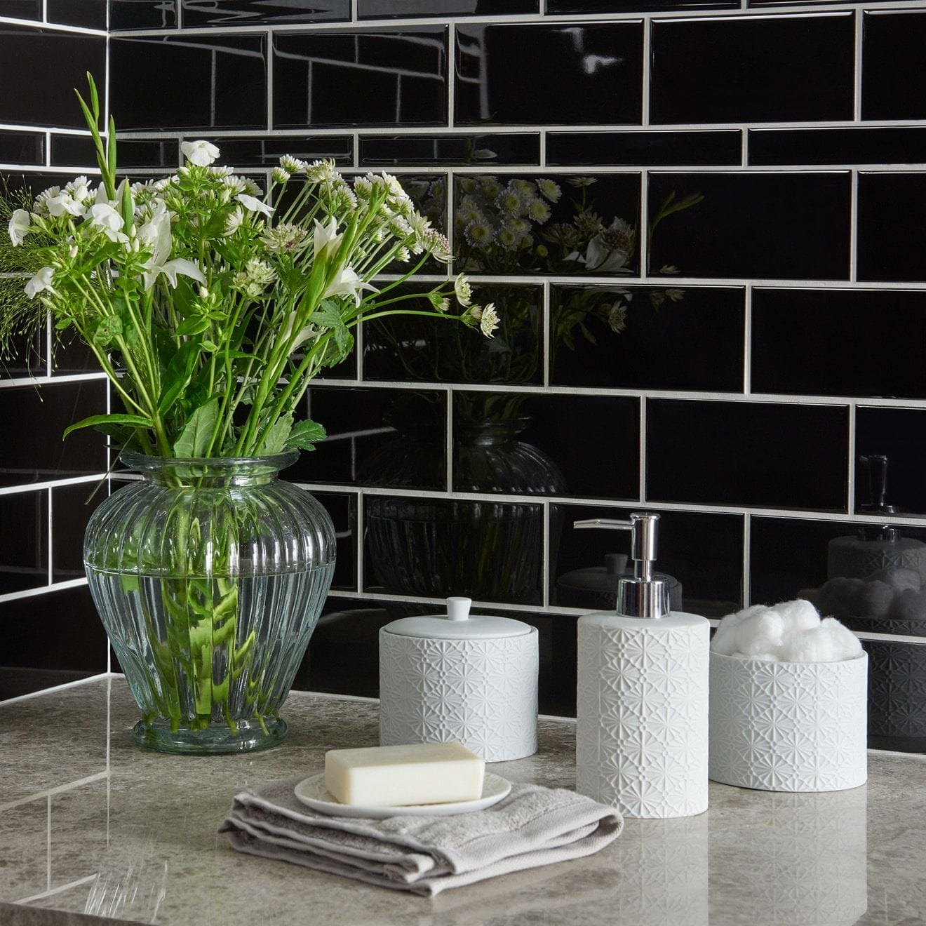 Jet black rectangle clear ribbed glass vase holding white flowers for elegant home decor