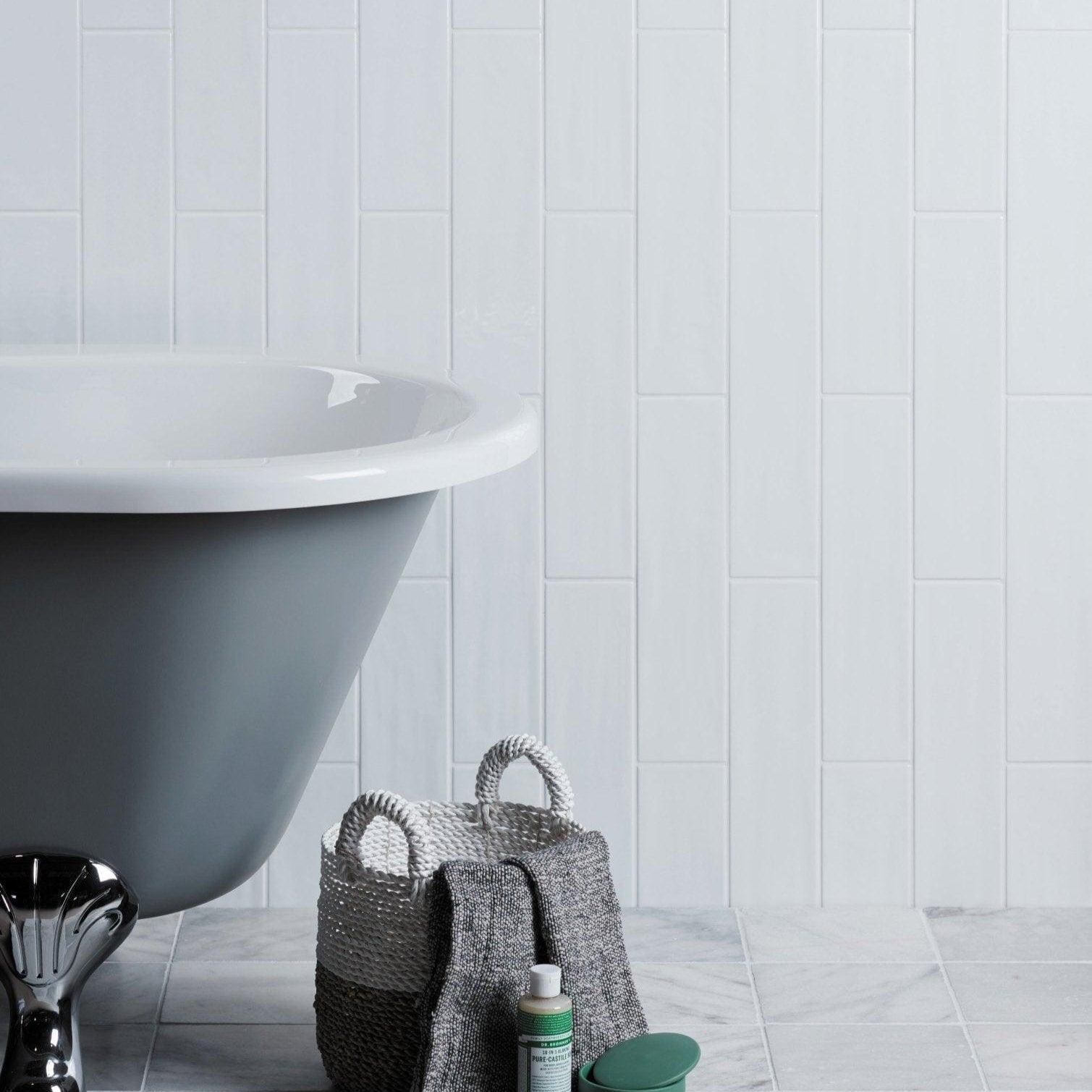 Gray freestanding Kennet porcelain chalk white bathtub with glossy finish and curved rim for stylish bathroom use