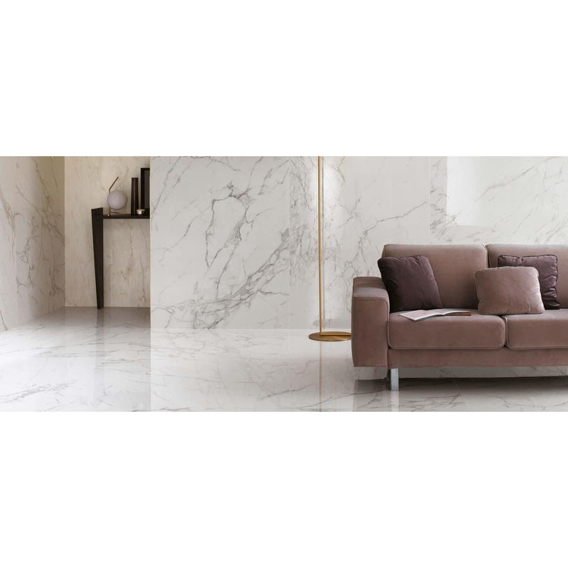 Marvel Calacatta Extra Matt 60 x 60cm white marble-effect tiles with a beige velvet sofa