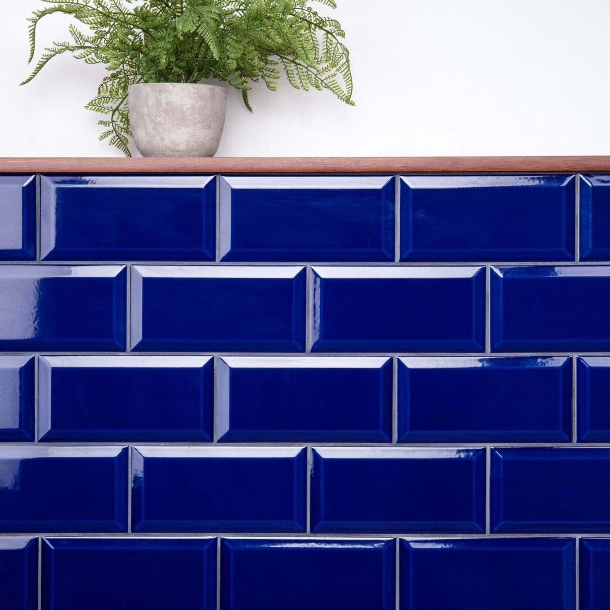 Deep blue glossy subway tiles arranged in a classic brick pattern from metro cobalto gloss collection