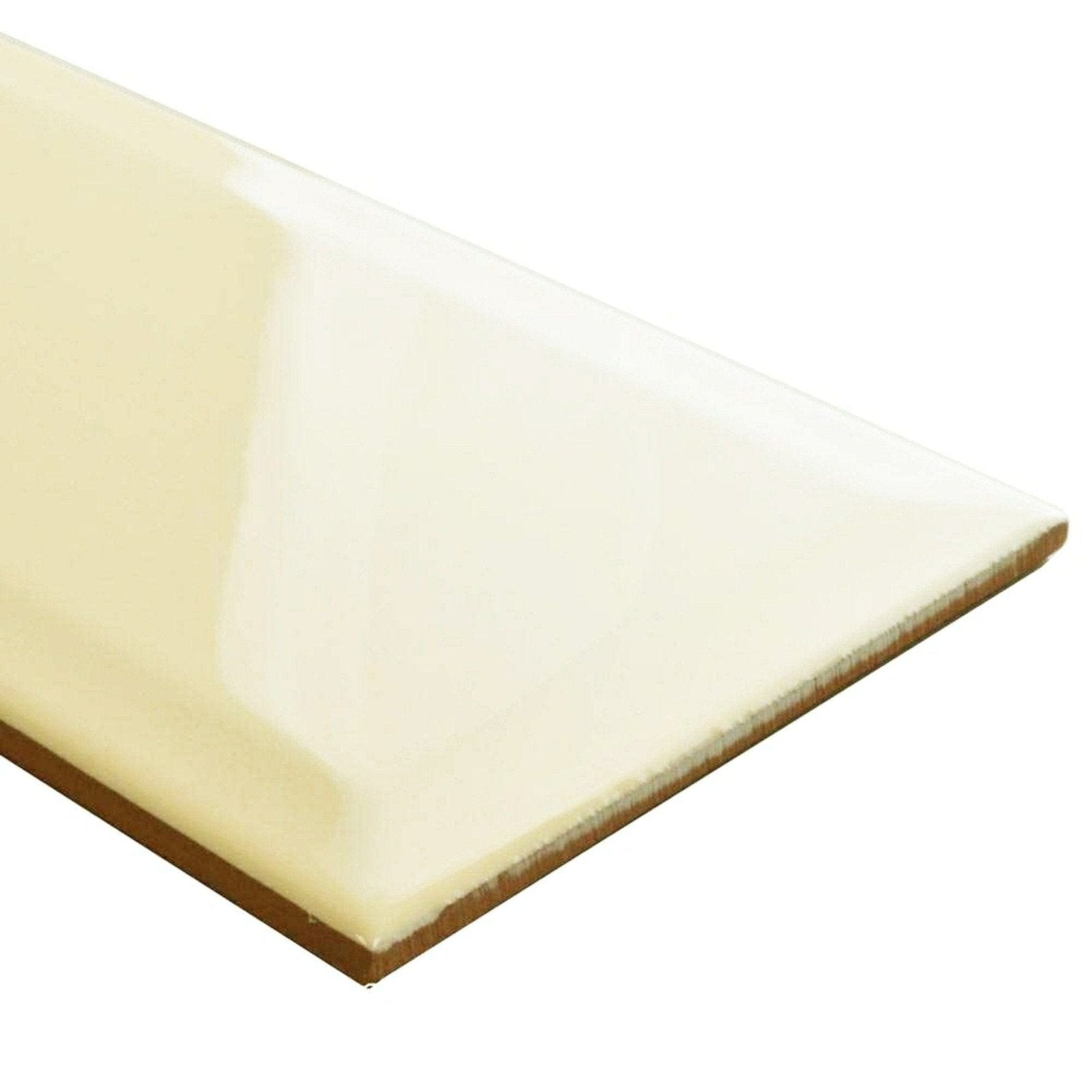Cream-colored glossy ceramic tile metro cream gloss with smooth reflective surface and visible brown backing shown from back side