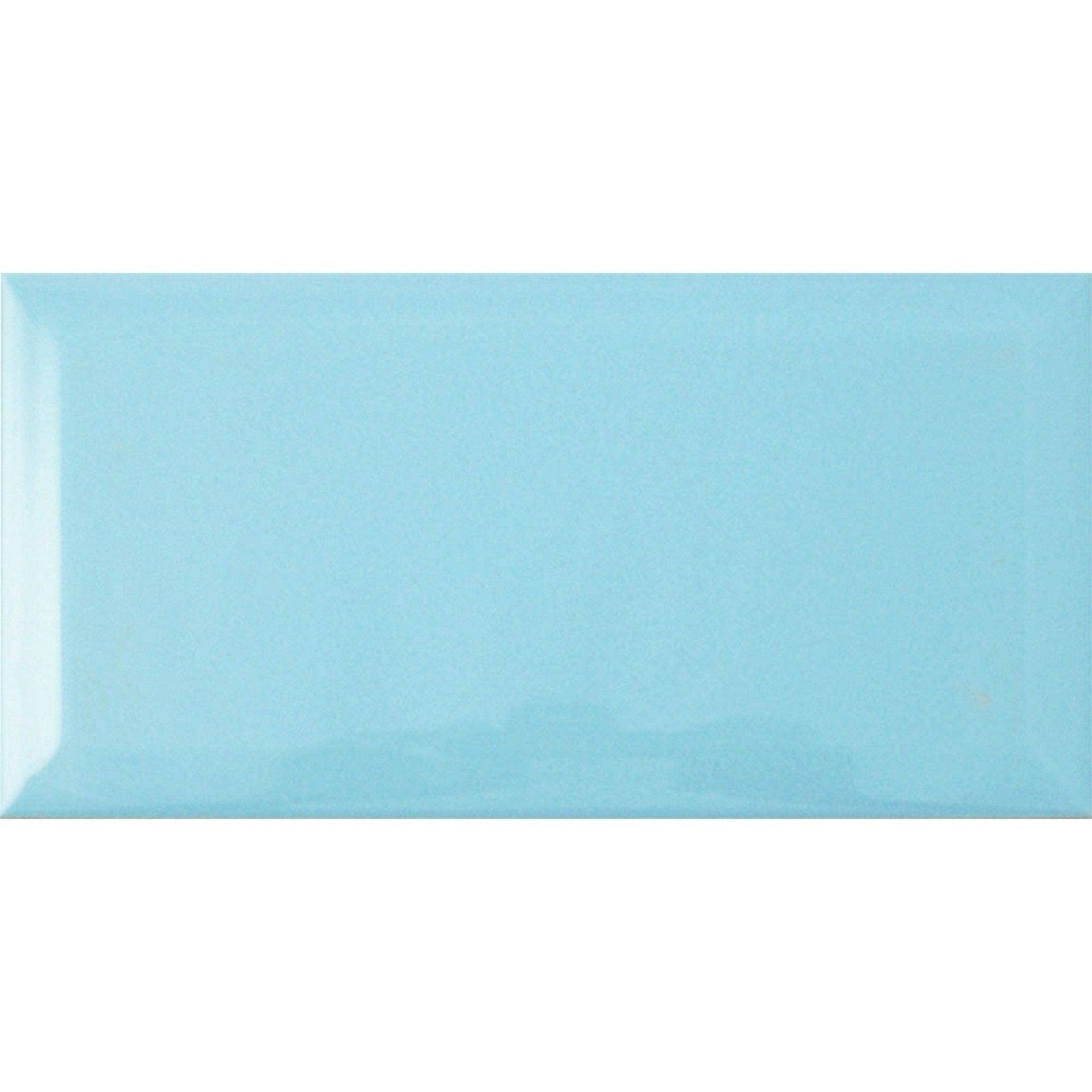 A rectangular glossy light blue ceramic tile with a smooth slightly reflective surface metro light blue gloss
