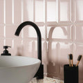 Metro Light Pink Gloss pink gloss ceramic tiles with a black tap and white sink