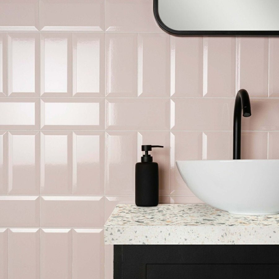 Metro Light Pink Gloss pink gloss ceramic tiles with a black soap dispenser