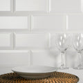 White ceramic bowl with a matte finish resting on a woven placemat in metro matt white collection