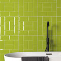 Vibrant lime green glossy subway tiles arranged in a herringbone pattern from metro menta gloss collection