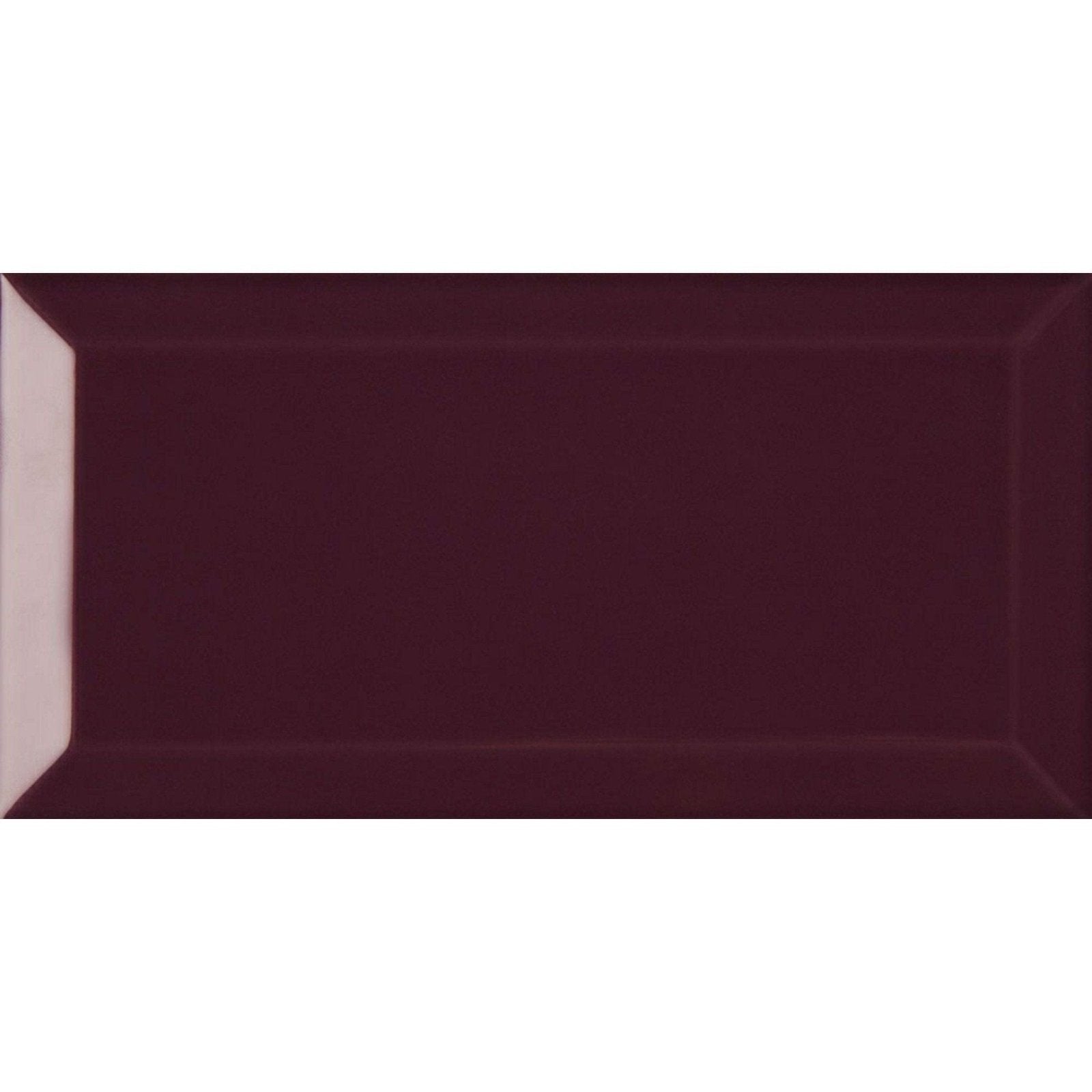 A rectangular glossy burgundy subway tile with a subtle raised border from metro plum gloss collection