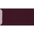 A rectangular glossy burgundy subway tile with a subtle raised border from metro plum gloss collection
