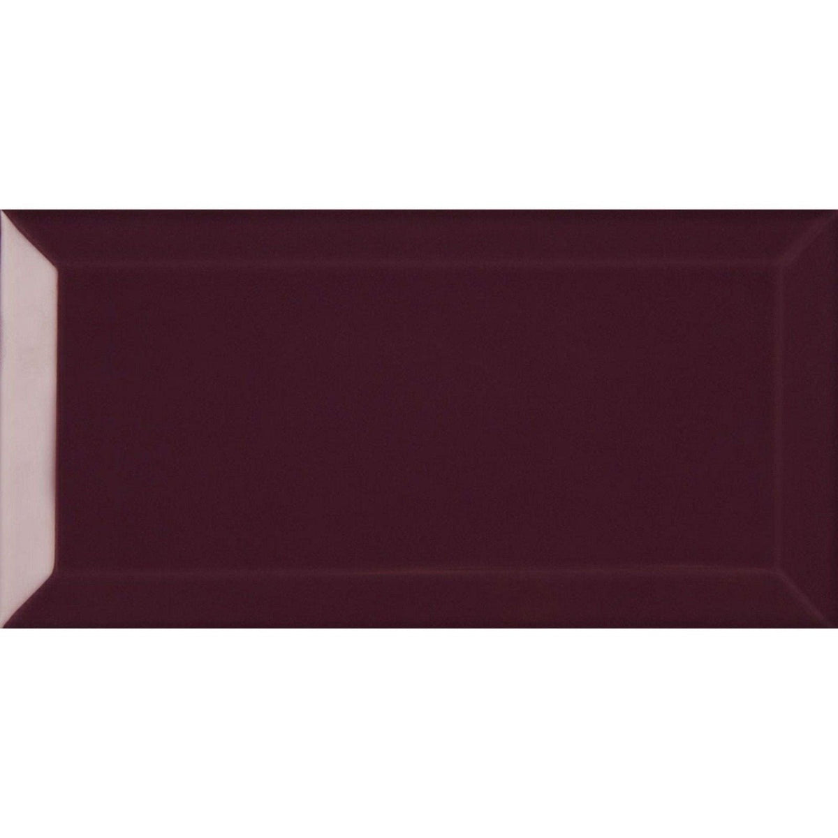 A rectangular glossy burgundy subway tile with a subtle raised border from metro plum gloss collection