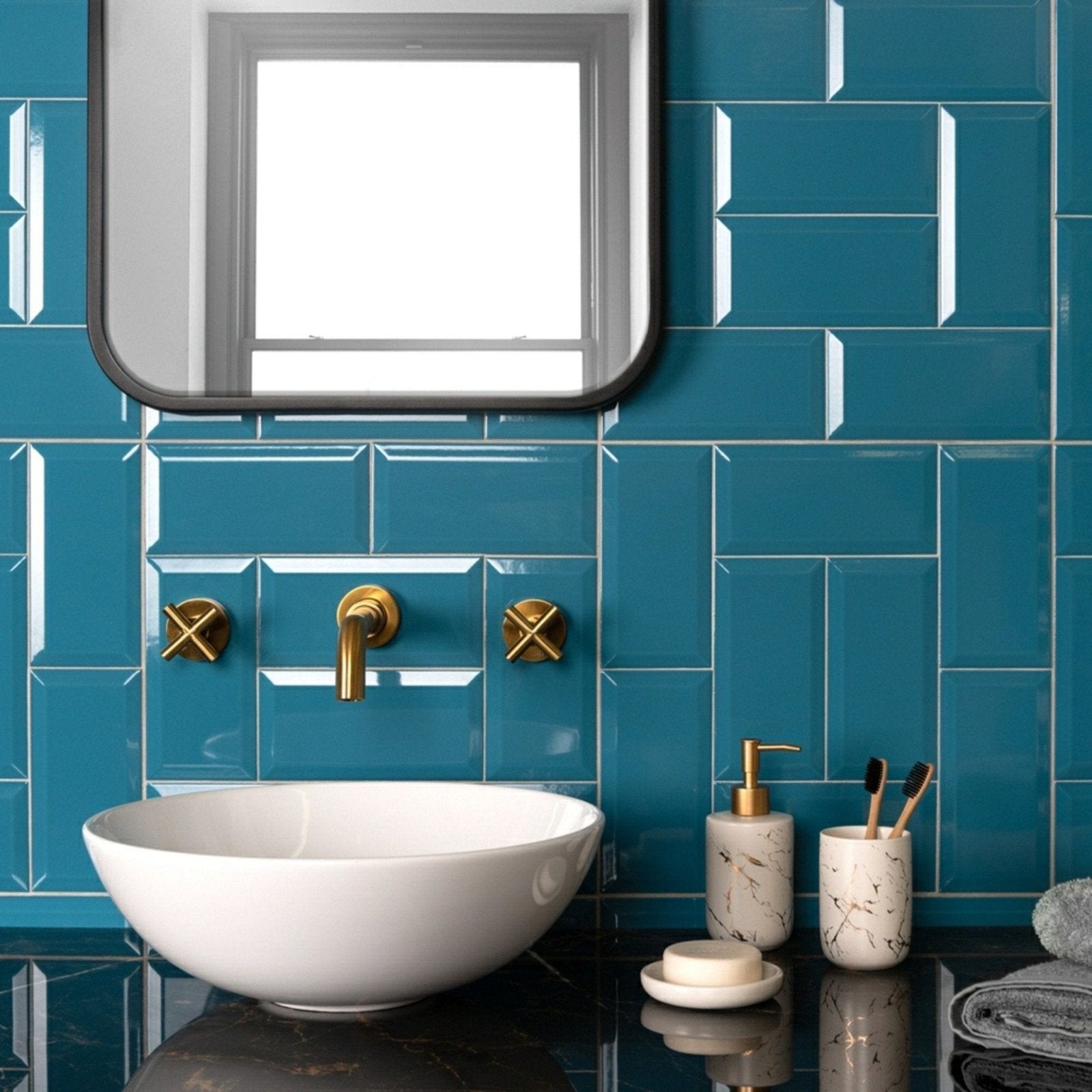 White ceramic bowl sink with gold-toned faucet and handles against teal metro teal gloss tiled wall