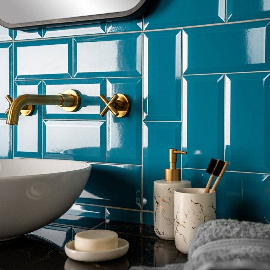 Gold-finished wall-mounted faucet metro teal gloss with sleek modern design and cross-shaped handle accents