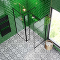 Black-framed glass shower screen with modern minimalist design set against vibrant green metro verde botella gloss tiles
