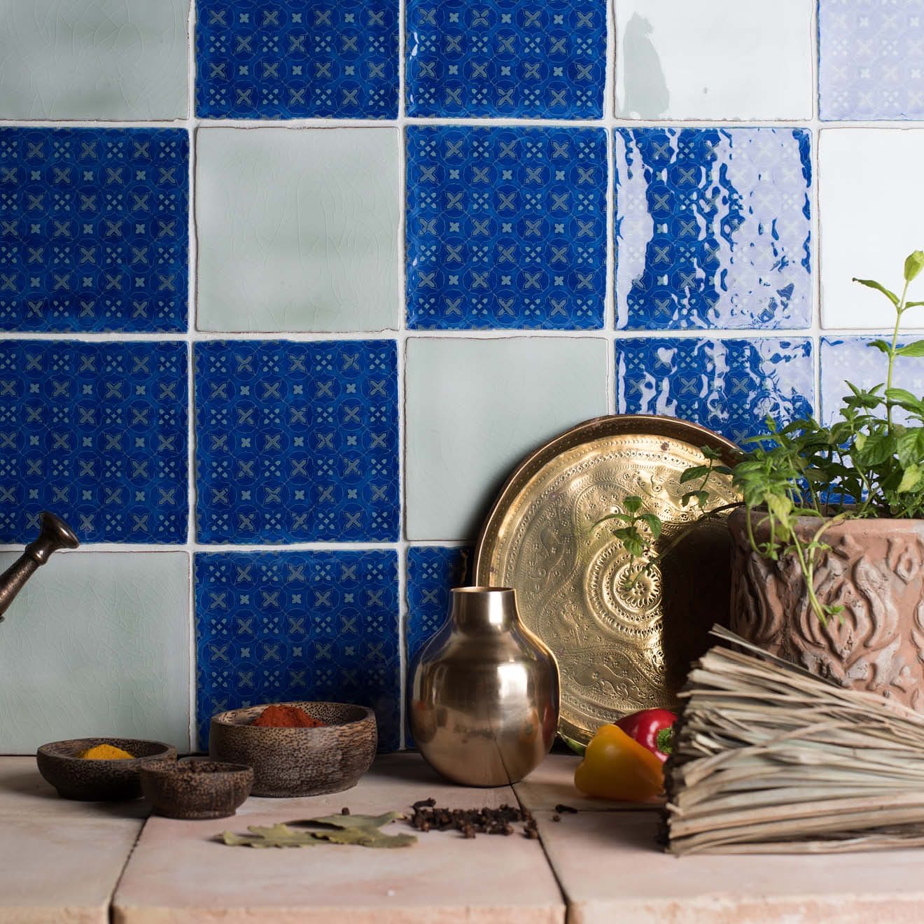 A small round metallic vessel with a smooth reflective surface and slightly flared rim in mint field tile style