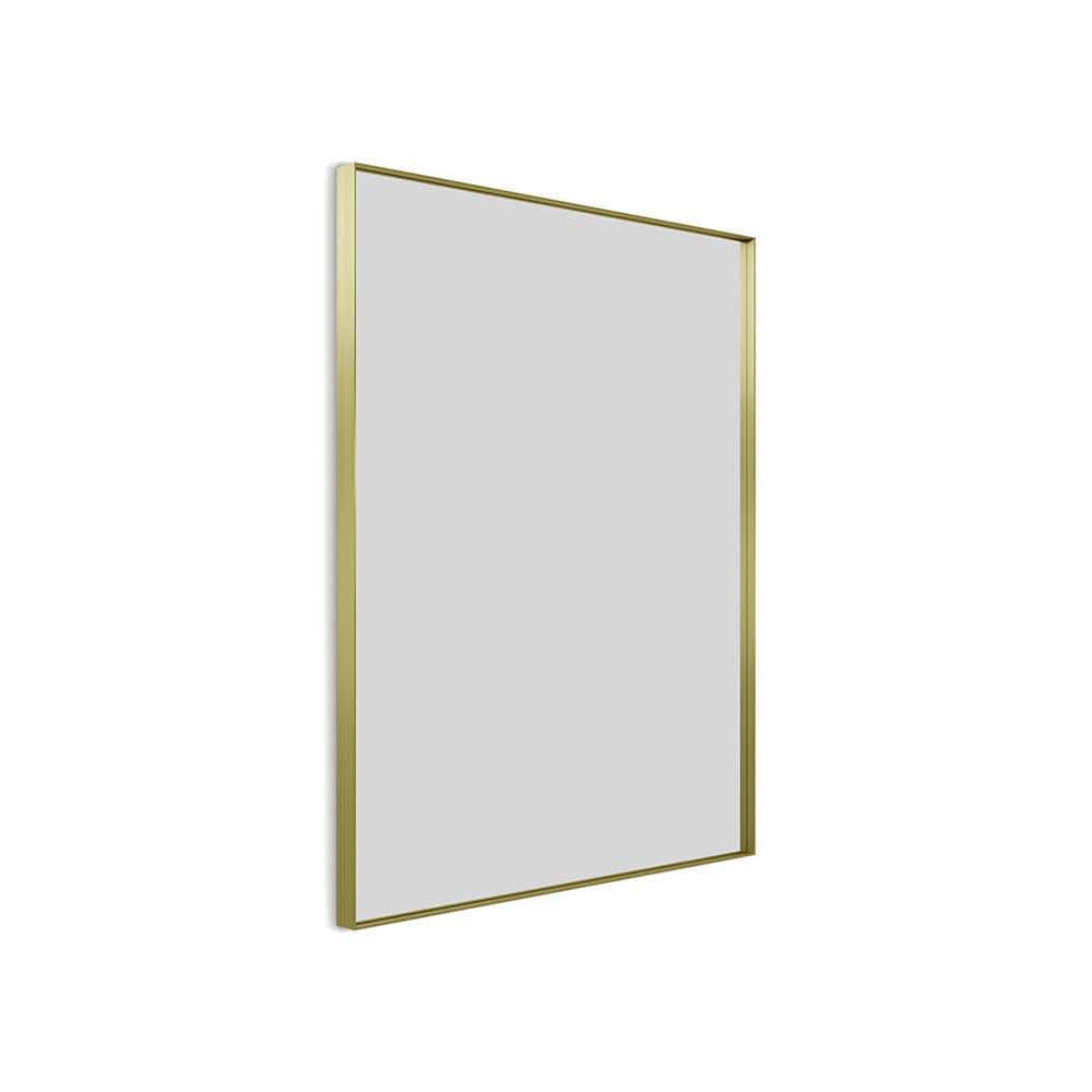 A sleek rectangular mirror with a thin polished gold frame in brushed brass measuring 100x80cm Newington model