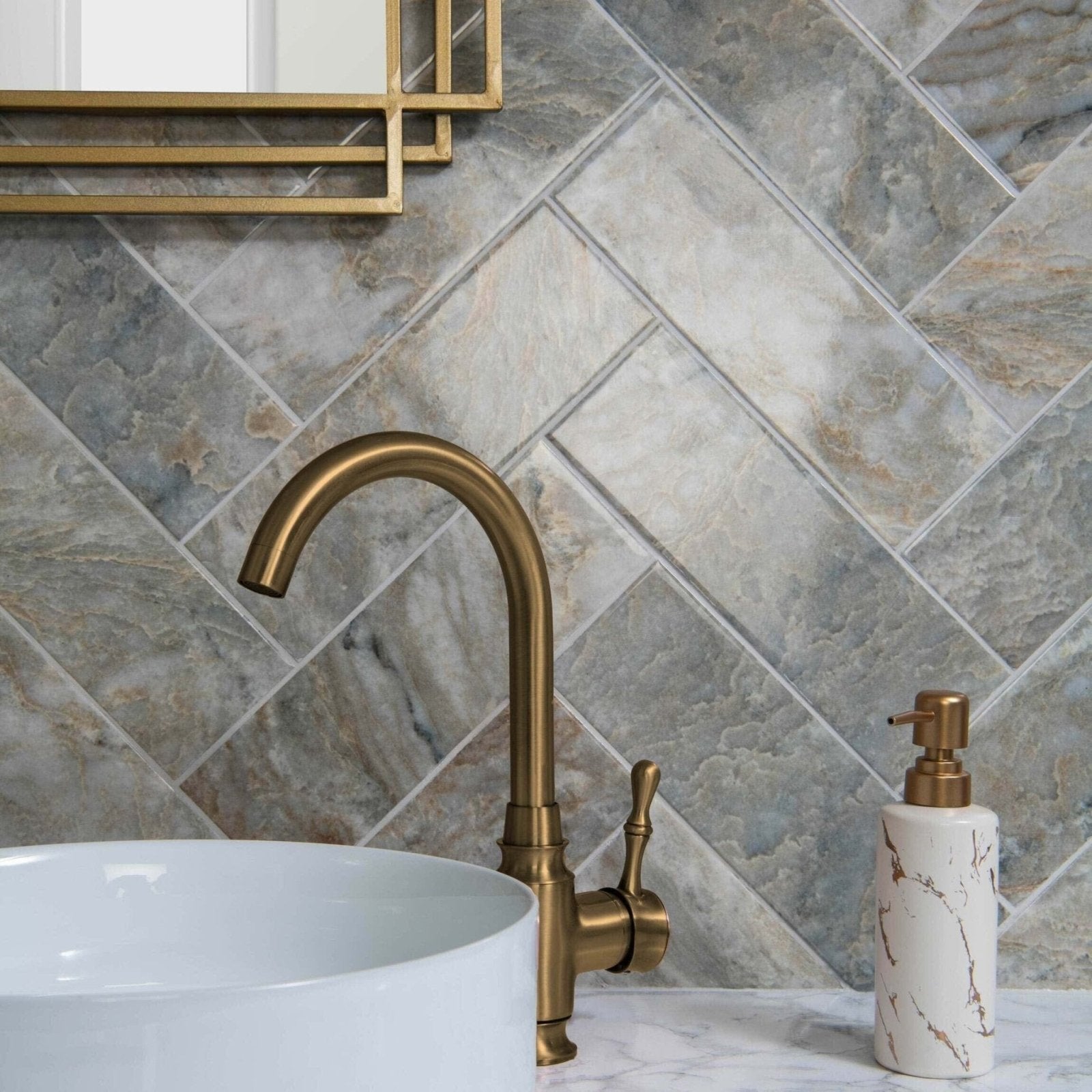 Onix Verde grey and beige marble-effect tiles with a brass gooseneck tap