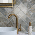 Onix Verde grey and beige marble-effect tiles with a brass gooseneck tap