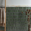 Palazzo Oro Marble Honed Moulding off-white marble moulding trim against dark green tiles