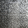 Pharaoh Decorative Glass black metallic glass tiles with an ornate showerhead