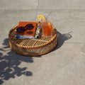 Pulse Carbon Tiles grey stone-effect paving with a woven rattan tray