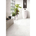 Python Onyx Porcelain Gloss white marble-effect tiles with a pedestal sink