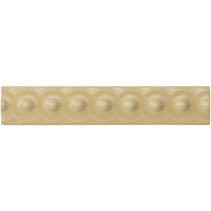 Regency cream scroll moulding cream-colored ceramic tile with raised rounded bead pattern along its length