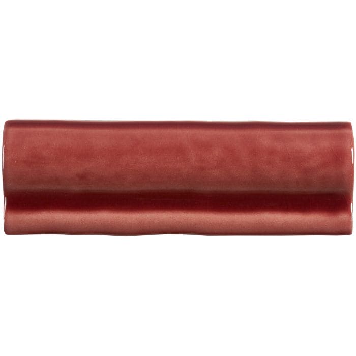 A rectangular glossy terracotta ceramic tile with rounded edges and textured surface from rioja torus moulding