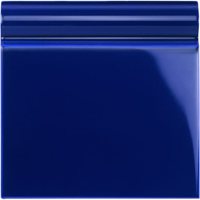 Royal blue skirting tile made of deep blue glossy ceramic with a raised ridged border for wall edging